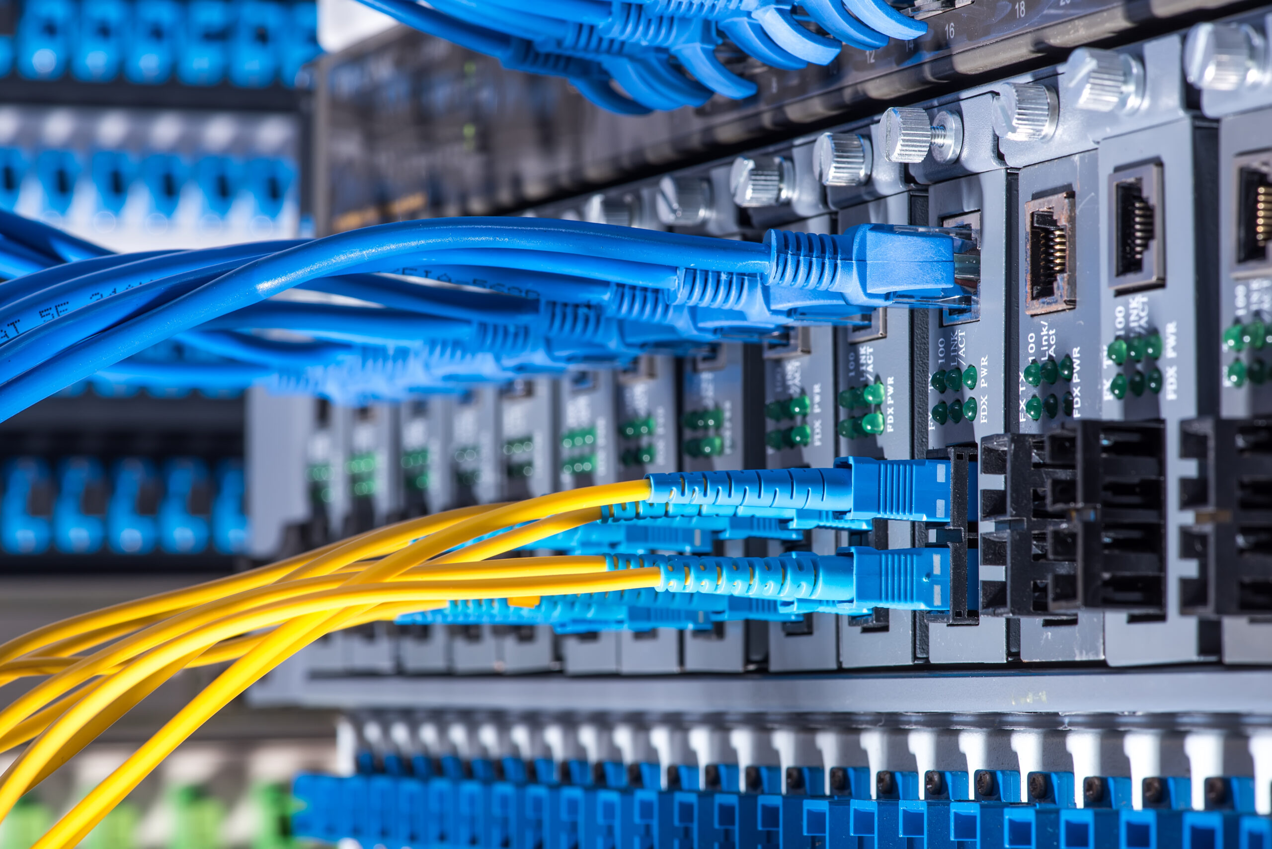 Fleet vehicle rental for telecom - image shows optic cables connected to an optic port and network cables connected to ethernet ports.