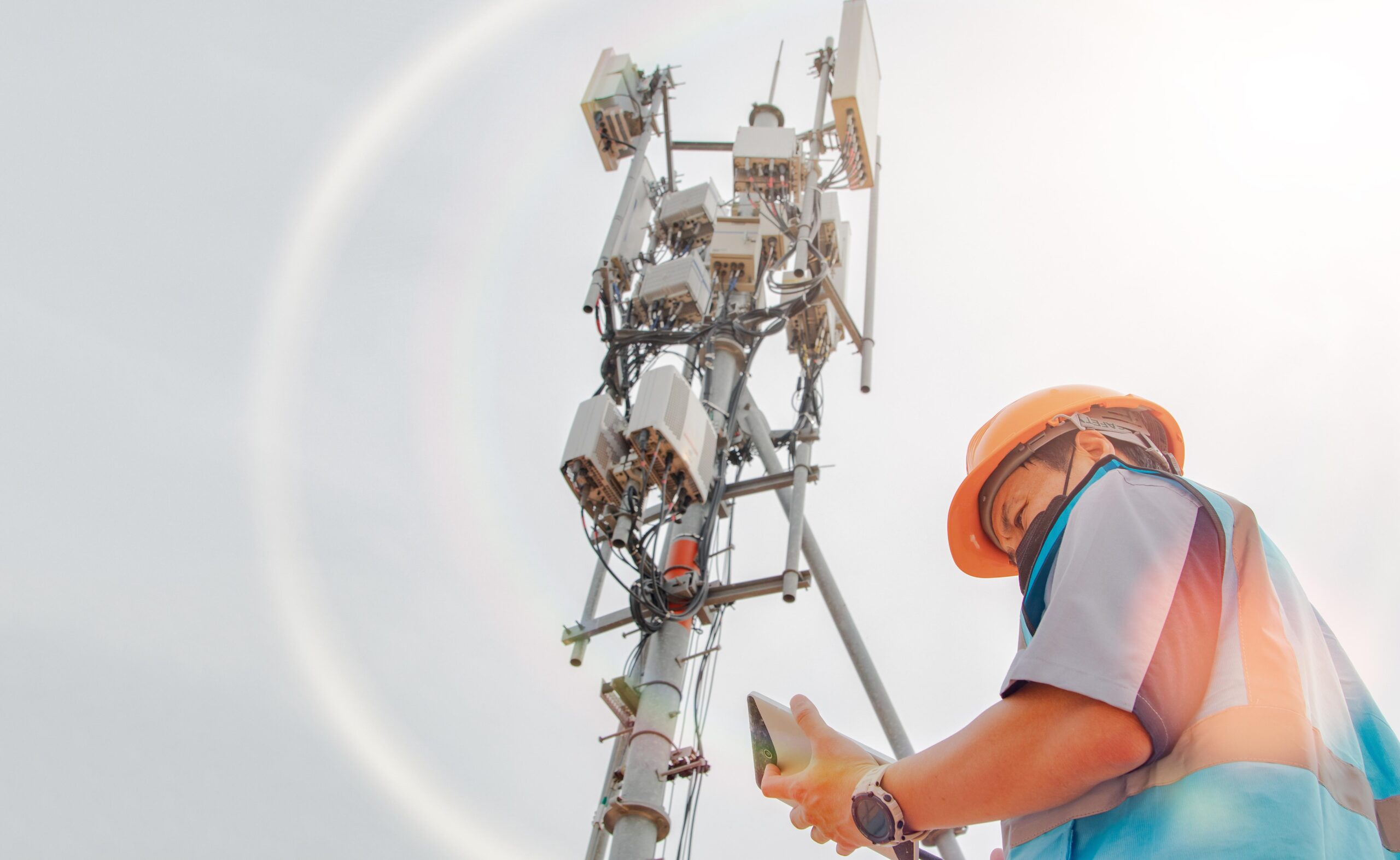 Fleet vehicle leasing for telecom - image shows a telecom engineer inspecting telecommunication tower structures